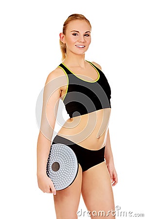 Young athletic woman holding balance board Stock Photo