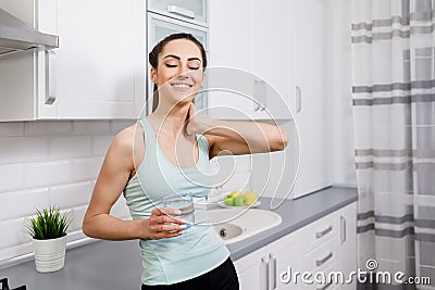 Young Athletic Woman in Tank Top Drinking Water Stock Photo