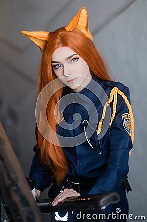 Young atteractive girl dressed as police oficer costume smiling with a cup Stock Photo