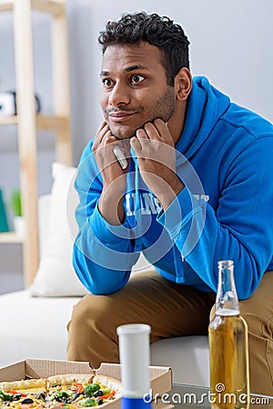 Young attractive african man watching television Stock Photo