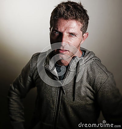 Young attractive angry and upset man looking with intense and threatening eyes as if scolding in aggressive attitude looking mad a Stock Photo