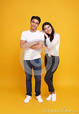 Young attractive Asian couple, man and woman wearing white t shirt and jeans. Teasing each other. Concept for pre wedding Stock Photo