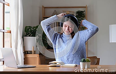 Young attractive asian female relax cross arm behind head use notebook digital online course program in quarantine at home reskill Stock Photo