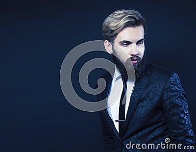 young attractive bearded hipster man gesturing emotional screaming in studio sucsess. fashion modern brutal guy Stock Photo