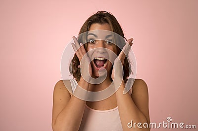 Young attractive and beautiful woman smiling excited and happy in nice shock and surprise showing positive face Stock Photo