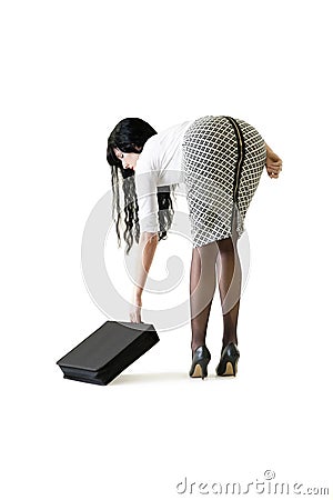 Young attractive business woman picking attache case up off floor Stock Photo