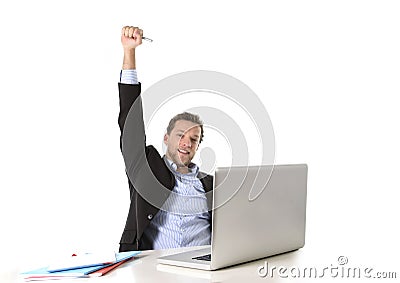 Young attractive businessman happy and hectic at office work sitting at computer desk satisfied celebrating Stock Photo