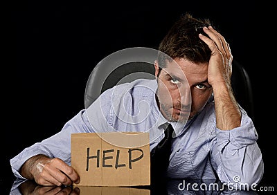 Young attractive businessman in worried tired and stressed face expression sitting depressed on office chair Stock Photo