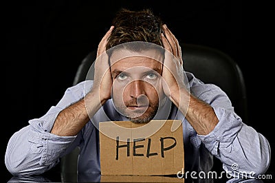 Young attractive businessman in worried tired and stressed face expression sitting depressed on office chair Stock Photo