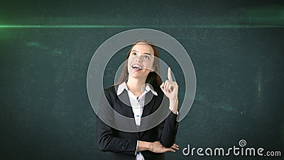 Young attractive businesswoman portrait in suit with standing and finger up, isolated studio background with copyspace. Stock Photo