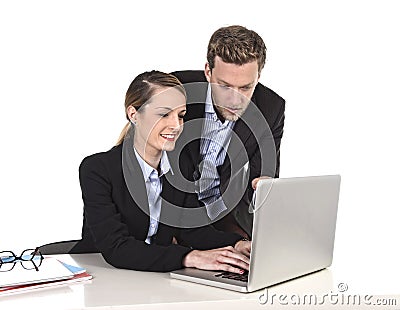 Young attractive businesswoman working at computer laptop in office talking with work colleague smiling relaxed Stock Photo