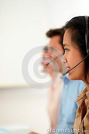 Young attractive callcenter people using earphone Stock Photo