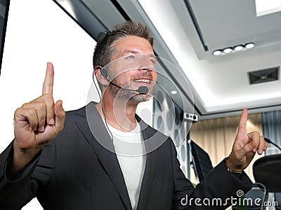 Young attractive and confident successful businessman with headset speaking at corporate company coaching and training at Stock Photo