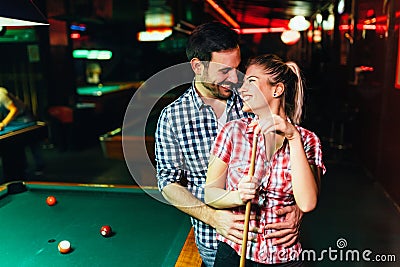 Young attractive couple on date in snooker club Stock Photo