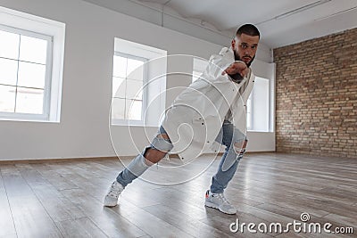Young attractive dancer in trendy jacket and ripped jeans Stock Photo