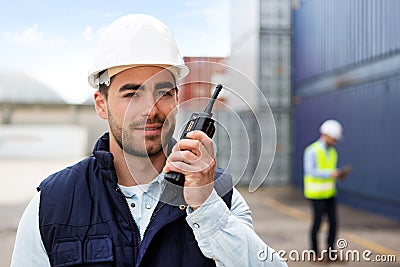 Young Attractive docker using talkie walkie at work Stock Photo