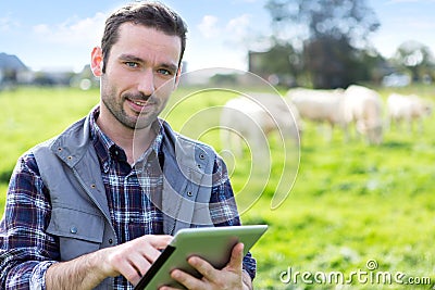 Young attractive farmer using tablet in a field Stock Photo