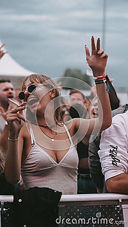 Young attractive female dancing during the electronic music festival Electrifinity in Bad Aibling Editorial Stock Photo