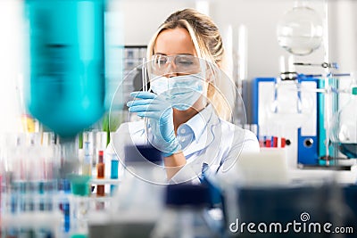 Young attractive female scientist preparing laboratory equipment Stock Photo