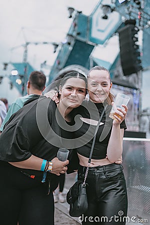 Young attractive females smiling during the electronic music festival Electrifinity in Bad Aibling Editorial Stock Photo