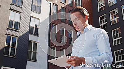 Young and attractive freelancer walking outdoor. Office worker or businessperson. Business and real estate. Stock Photo