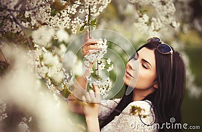Young attractive girl loves lilic flower garden Stock Photo