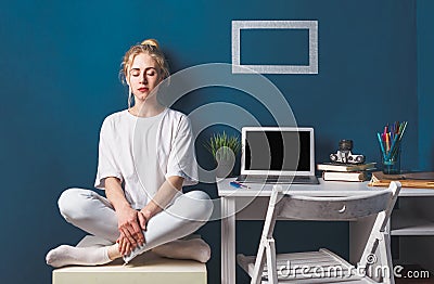 Young Attractive Girl Sitting In Lotus Position Near Desktop Work Place Stock Photo