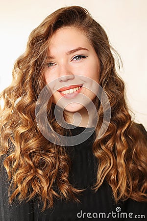 Young attractive girl smiling with dimples and curls of blond ha Stock Photo