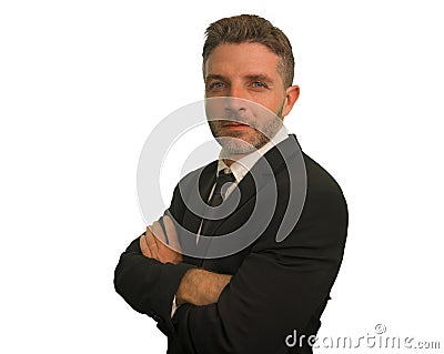 Young attractive happy and confident businessman in suit and necktie posing with folded arms for corporate company portrait in Stock Photo