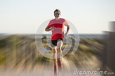 Young attractive and happy sport runner man with fit and strong healthy body training on off road track in Summer running workout Stock Photo