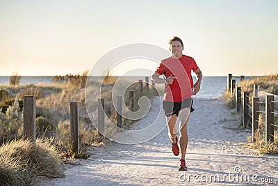 Young attractive and happy sport runner man with fit and strong healthy body training on off road track in Summer running workout Stock Photo