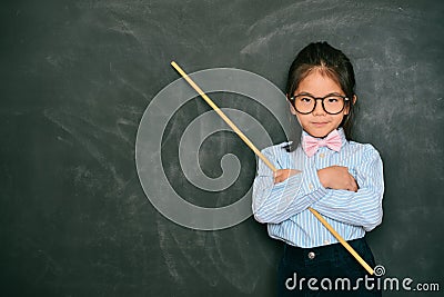 Attractive little female teacher holding stick Stock Photo