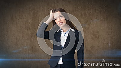 Young attractive longhair businesswoman in suit stressed and holding her head in fatigue, studio background Stock Photo