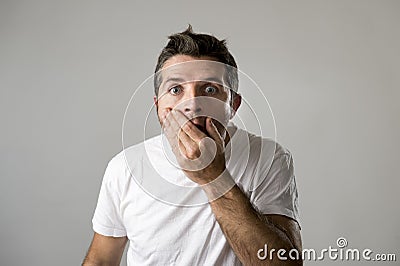 Young attractive man astonished amazed in shock surprise face expression and shock emotion Stock Photo