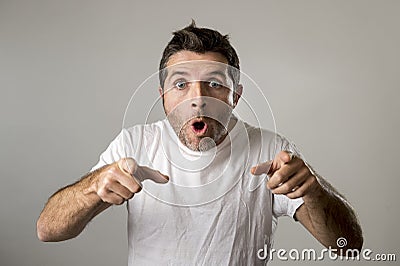 Young attractive man astonished amazed in shock surprise face expression and shock emotion Stock Photo