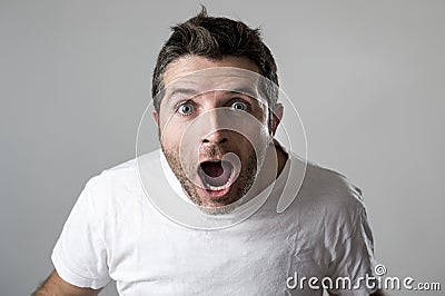 Young attractive man astonished amazed in shock surprise face expression and shock emotion Stock Photo