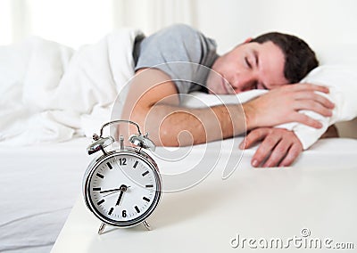 Young attractive man sleeping on bed Stock Photo