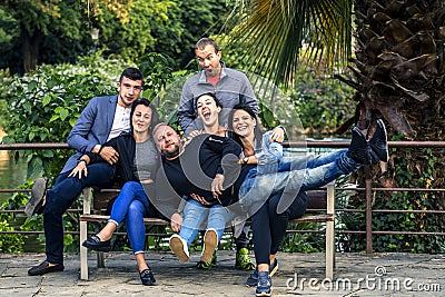 Young and attractive people are sitting on a bench in ghetto street. Stock Photo