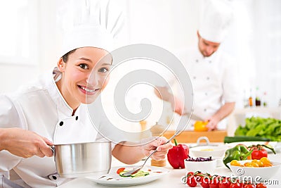 Young attractive professional chef cooking in his kitchen Stock Photo