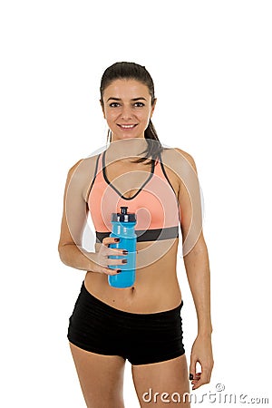 Young attractive sport woman in fitness clothes smiling happy posing with water bottle Stock Photo