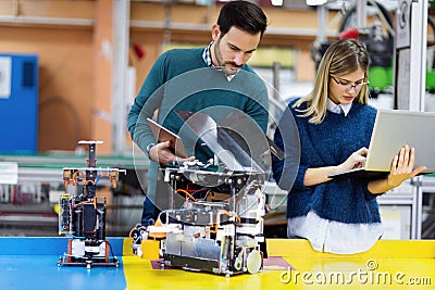 Young attractive students of mechatronics working on project Stock Photo