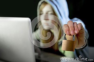 young attractive teen woman wearing hoodie hacking laptop cybercrime cyber crime concept Stock Photo
