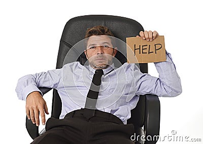 Young attractive tired and wasted businessman sitting on office chair asking for help in stress Stock Photo