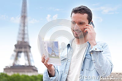 Young attractive tourist reading a guide of Paris Stock Photo