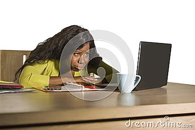 Young attractive unhappy and exhausted black afro American woman working lazy on Monday at office computer desk feeling overwhelme Stock Photo