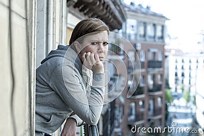 Young attractive unhappy lonely woman suffering from depression looking sad on the balcony at home Stock Photo