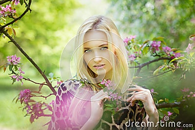 Young attractive woman in blooming spring trees Stock Photo