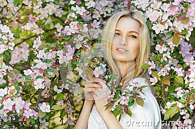 Young attractive woman in blooming spring trees Stock Photo