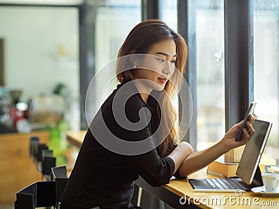 Young attractive woman with casual looks looking on her smartphone Stock Photo