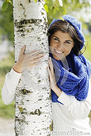 Young attractive woman close to a birch tree Stock Photo